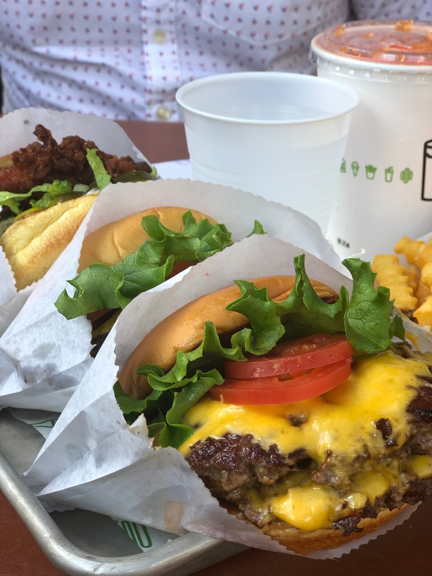 Tray of fast food with burgers, fries and drinks